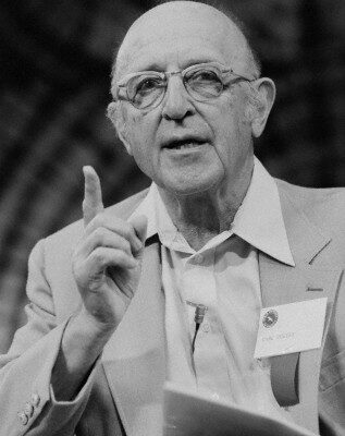 ca. April 8-15, 1979, Los Angeles, California, USA --- Psychotherapist Carl Rogers listens as he acts as keynote speaker at the World Symposium on Humanity in 1979. Rogers was one of the founders of humanistic psychology, which promotes a more person-to-person approach to the traditional therapist-patient relationship, and emphasizes the responsibility and intention in human behavior, as opposed to the more determinant ideas inherent in behaviorism and psychoanalysis. --- Image by © Roger Ressmeyer/CORBIS